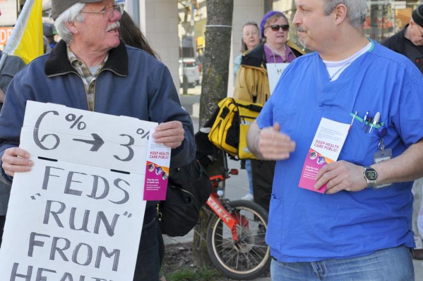 HEU member Gino Porco (right) and three dozen other citizens protest Conservative cuts at Richmond's afternoon rally