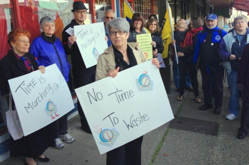 Large Vancouver crowd kicks-off first of six rallies at federal Conservative MPs' offices held across B.C. on March 31
