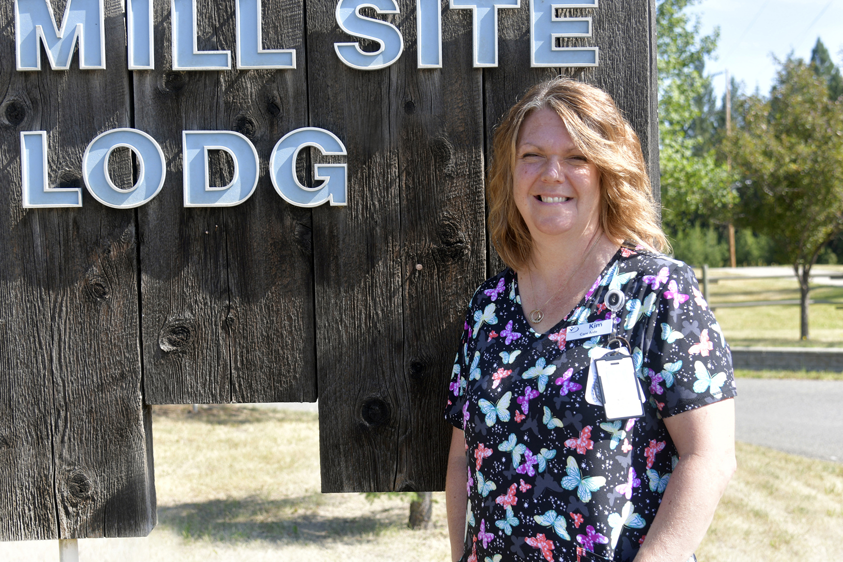 HEU member in front of her facility