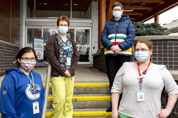 Members on steps of facility