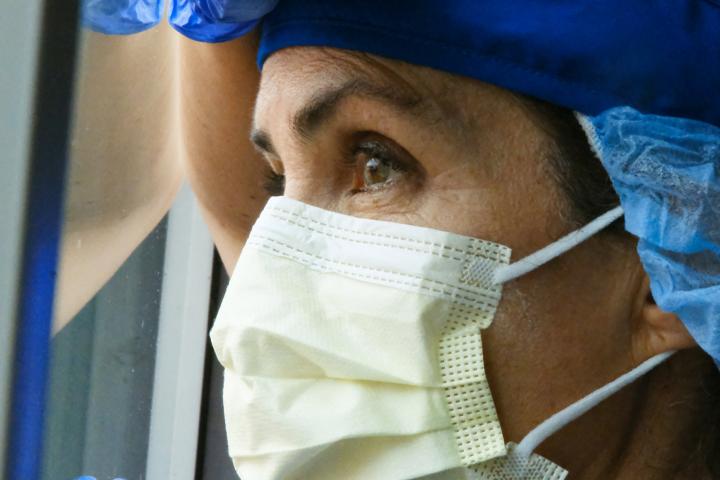health care worker looking out window