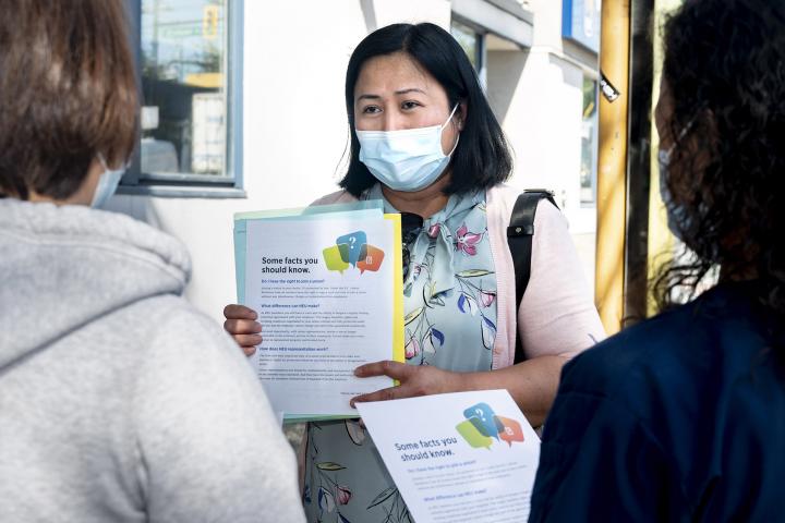 HEU organizer talking with health care workers