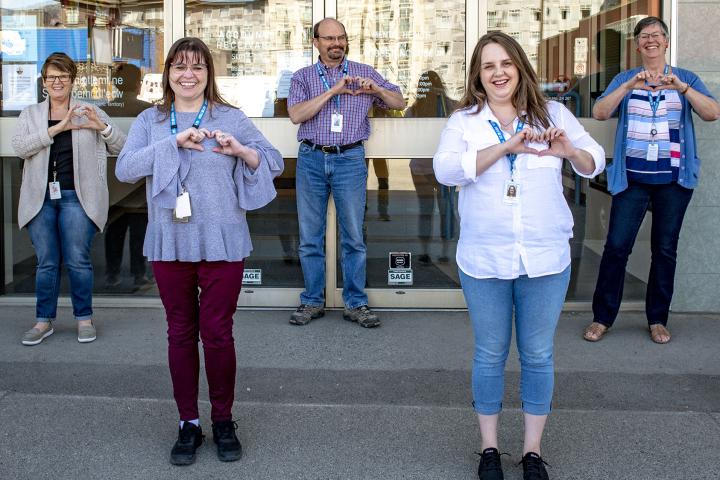 HEU members standing in a group outside their facility