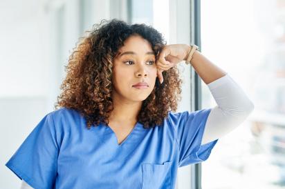 Health care worker gazing out window