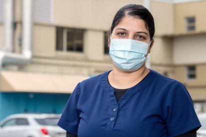 Food service worker wearing mask outside hospital