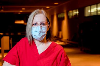 housekeeper wearing mask in front of hospital