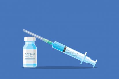 Covid 19 vaccine and syringe with blue background