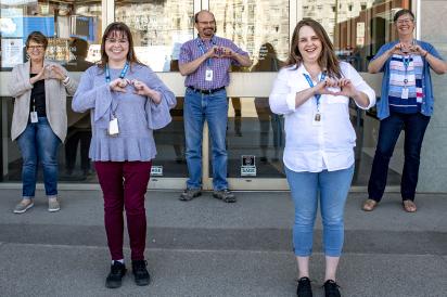 HEU members standing in a group outside their facility