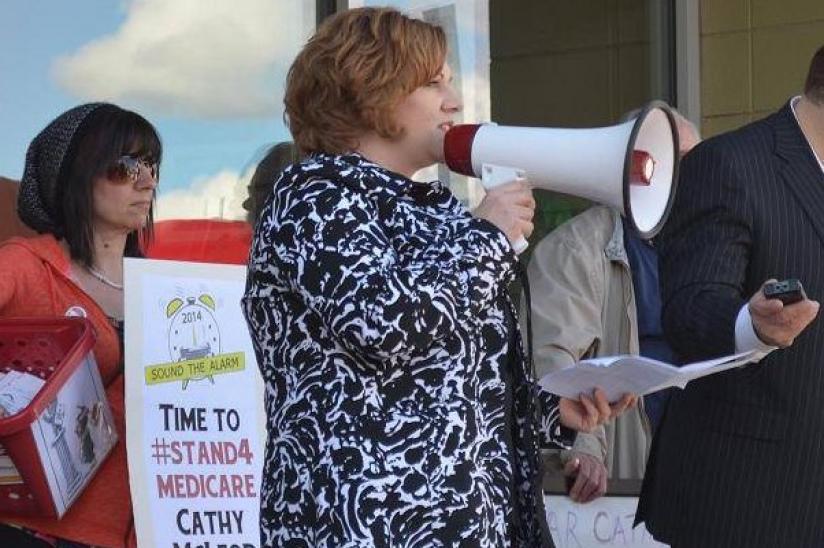 HEU rally organizer Barb Nederpel speaks to crowd before dropping off 900-plus postcards against cuts at Kamloops MP's office