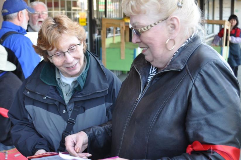 HEU regional vice-president Bev Trynchy hands out information about the cuts to passersby