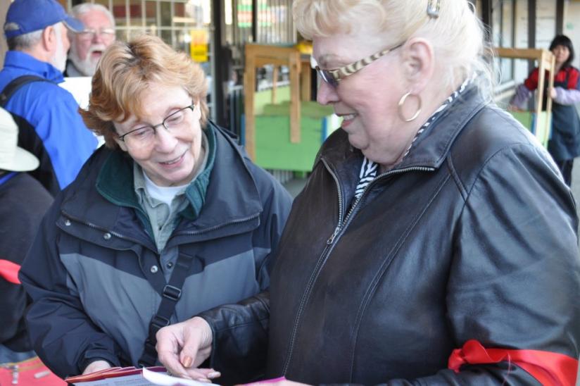 HEU regional vice-president Bev Trynchy hands out information about the cuts to passersby