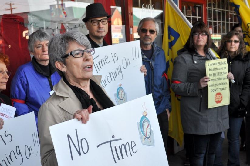 HEU secretary-business manager Bonnie Pearson speaks to the 100-plus crowd in front of MP Wai Young's office in Vancouver