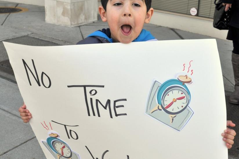 Young health care supporter in Richmond gets into the rally spirit in front of MP Alice Wong's office