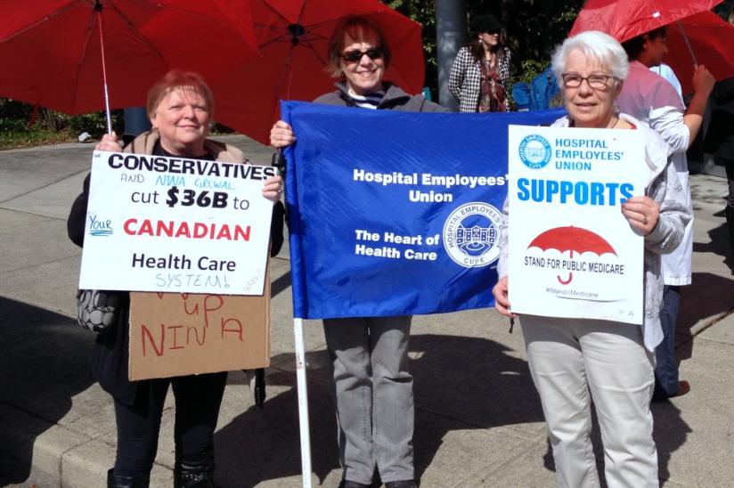 More than two dozen attend the lunchtime Surrey rally to protest health care cuts