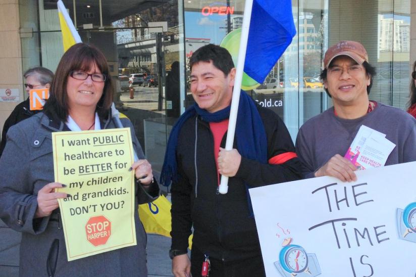 Richmond rally organizer David Huespe (centre) rallies with union members from HEU and BCGEU