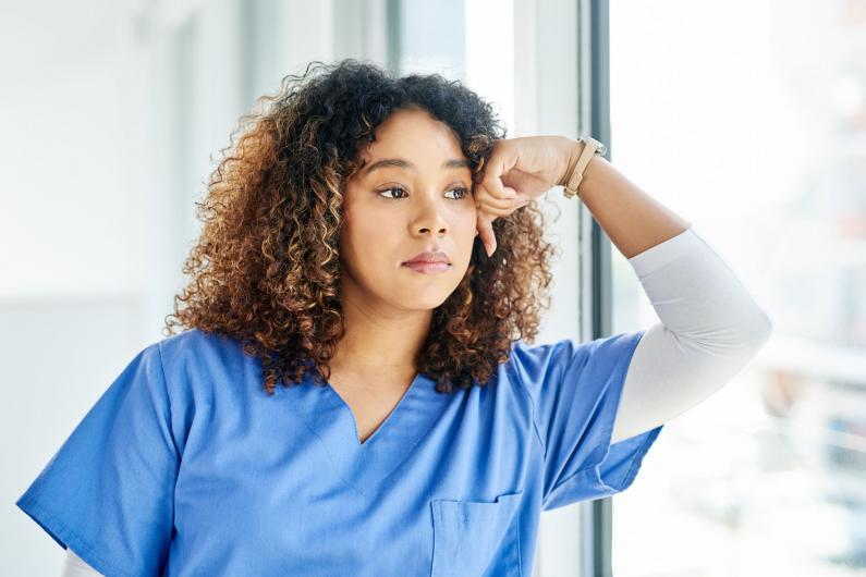 Health care worker gazing out window