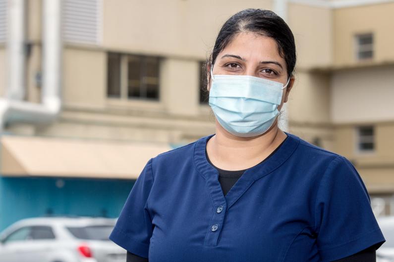 Food service worker wearing mask outside hospital