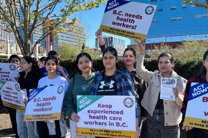 HEU members at a PNP rally - holding signs